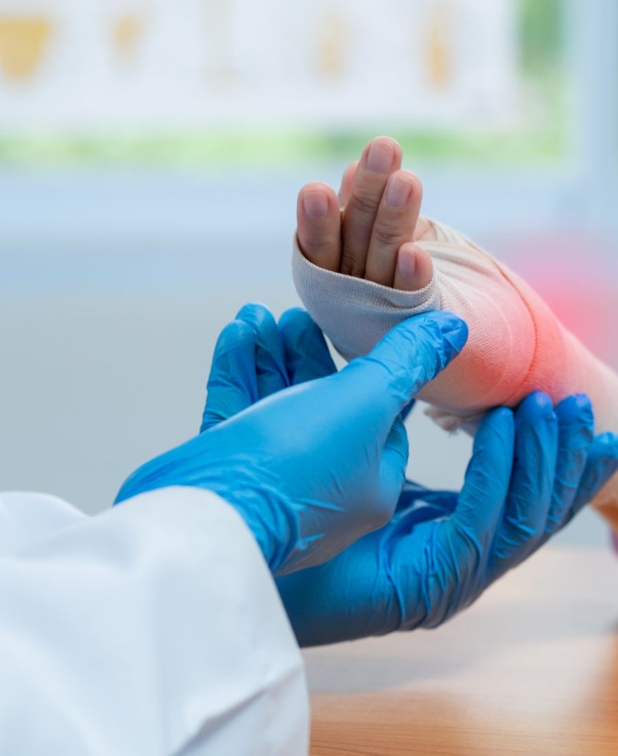 Orthopedic doctor wear medical gloves Of Doctor Hand Tying Bandage On The wrist inflammation Of Patient In Clinic